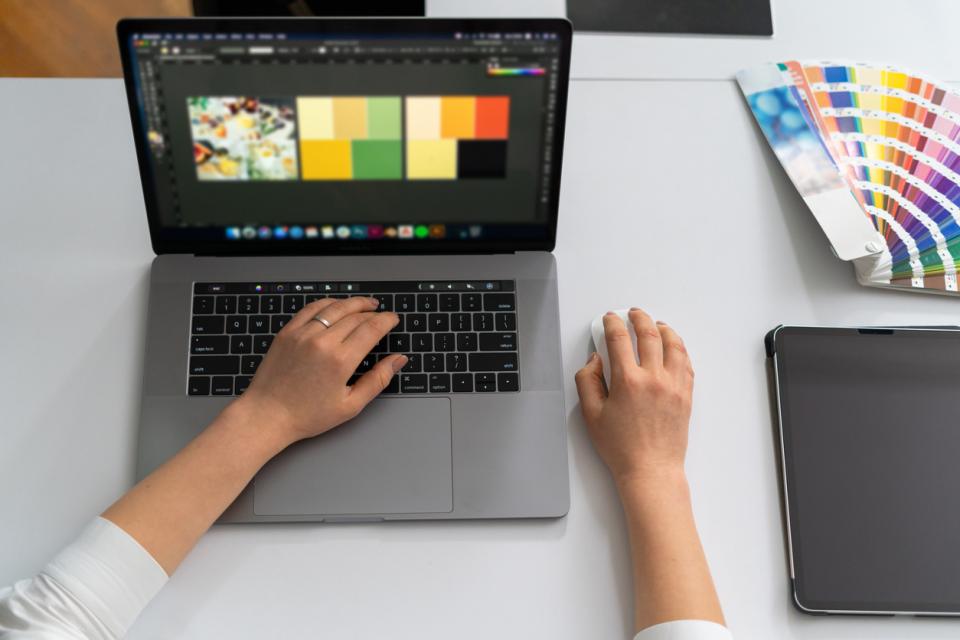 A teacher designing an infographic on her laptop