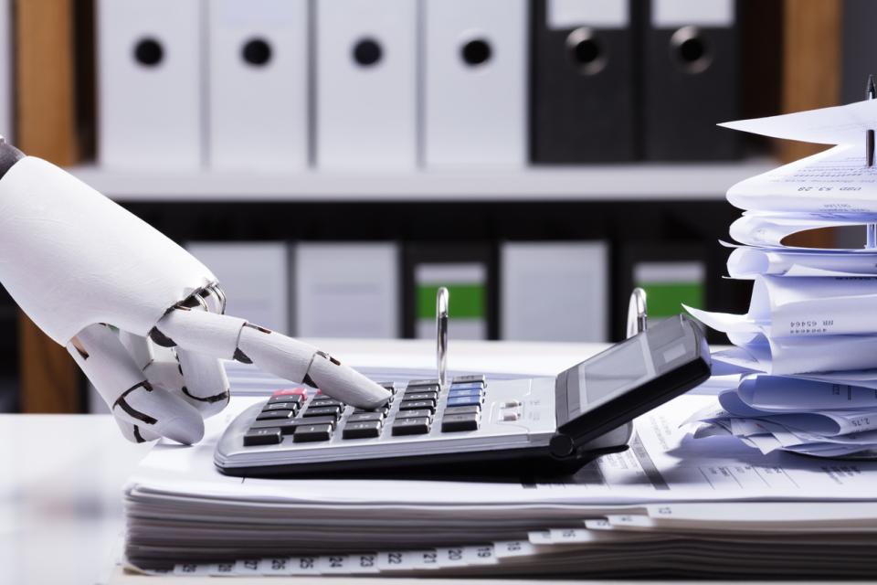 A robot hand using a calculator