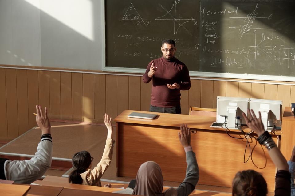 A lecturer standign at the front of class