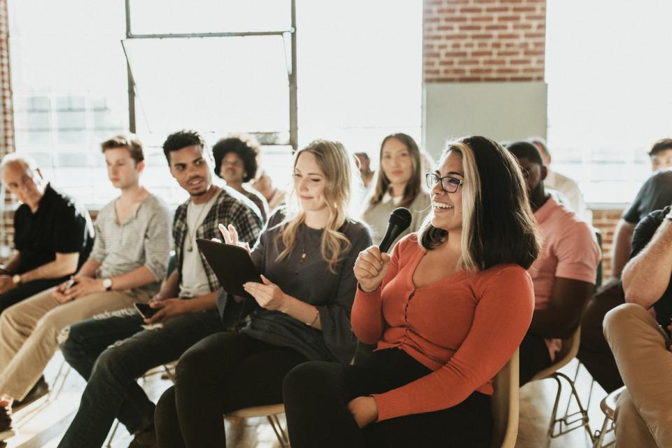 Students speaking at a meeting.
