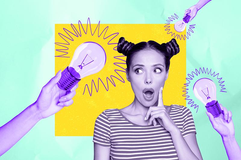 Young woman surrounded by light bulbs, creative concept