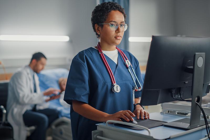 Nurse entering information into computer