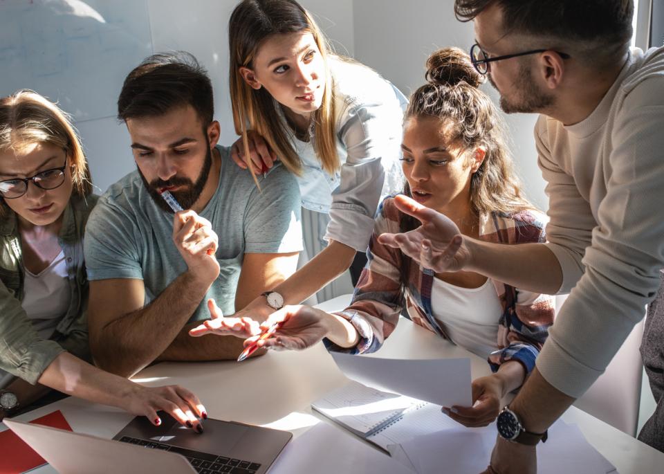 Students discussing a group project in class