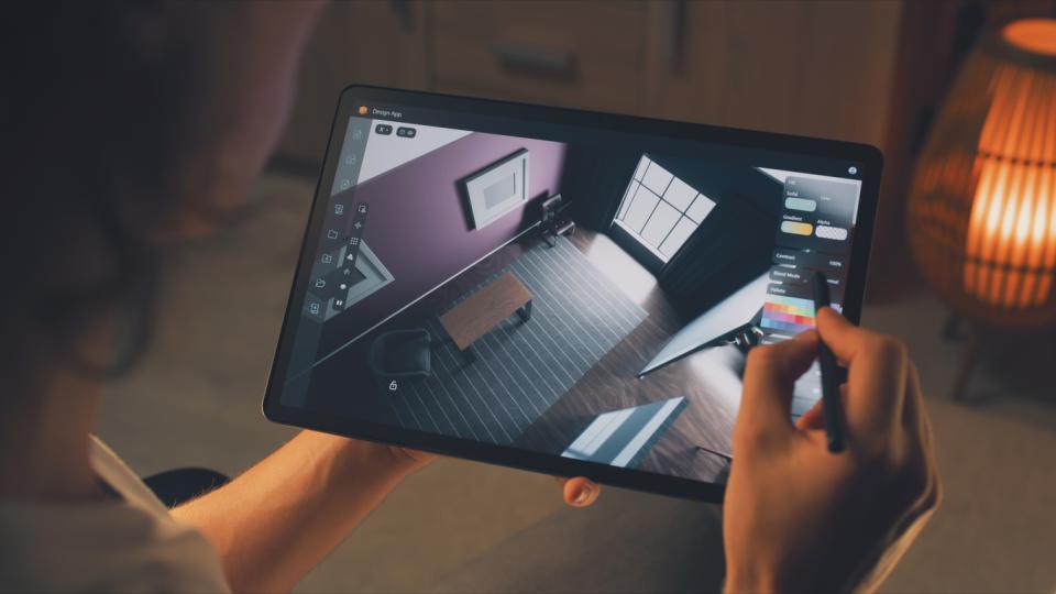 A tablet with a floor plan being held 