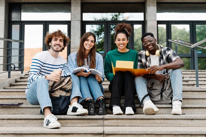 A happy group of students pose on a flight of steps