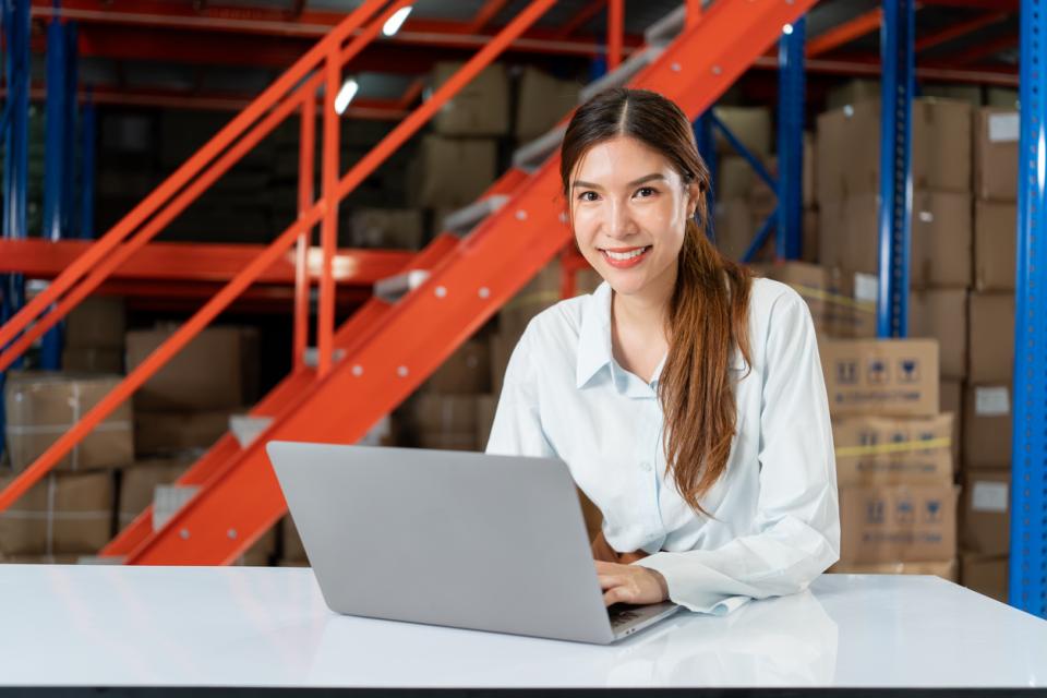A logistics student working at her laptop