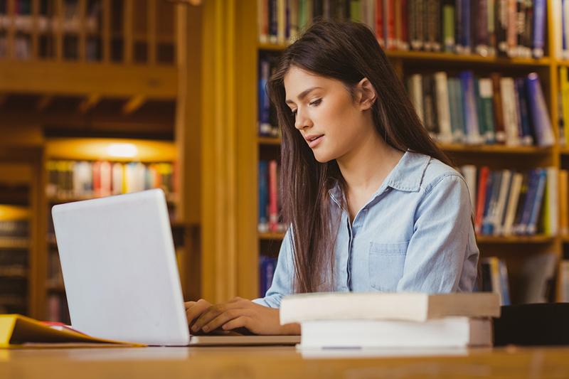 Young scholar working in library