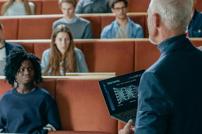 University professor teaching with laptop
