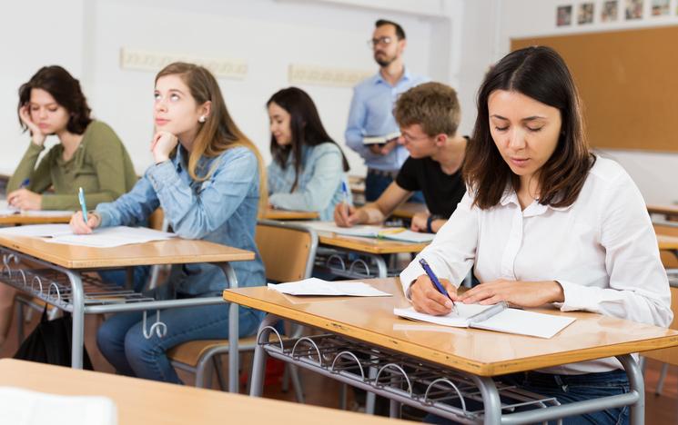 Students sit an exam in a classroom