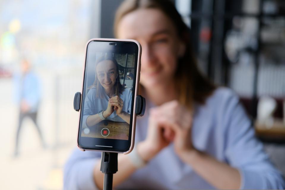 A student filming herself on her phone