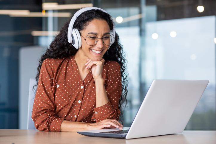 A student wears headphones while on a Zoom call