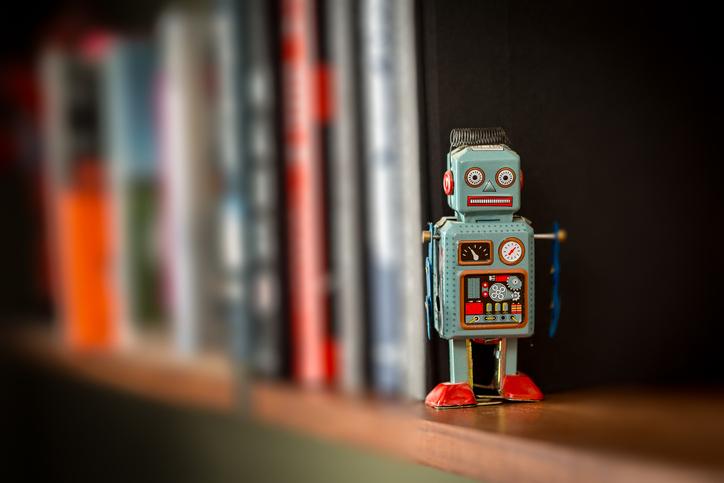 A toy robot stands on a shelf