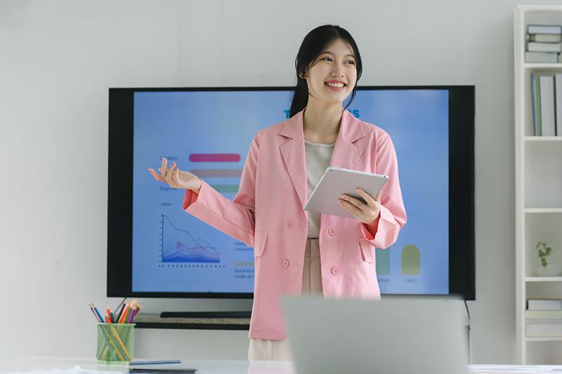 Young Asian female students giving presentation