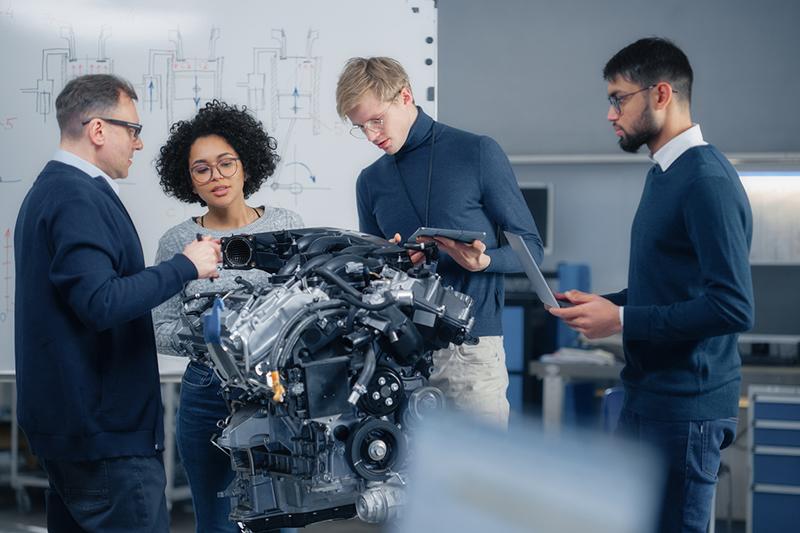 Team of engineers working on an engine