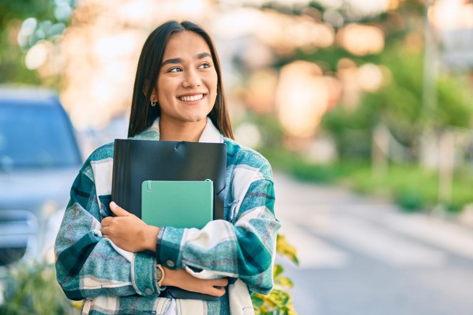 A university student standing outside a campus building 