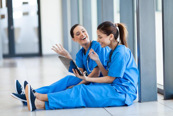 Nurses laugh with an iPad