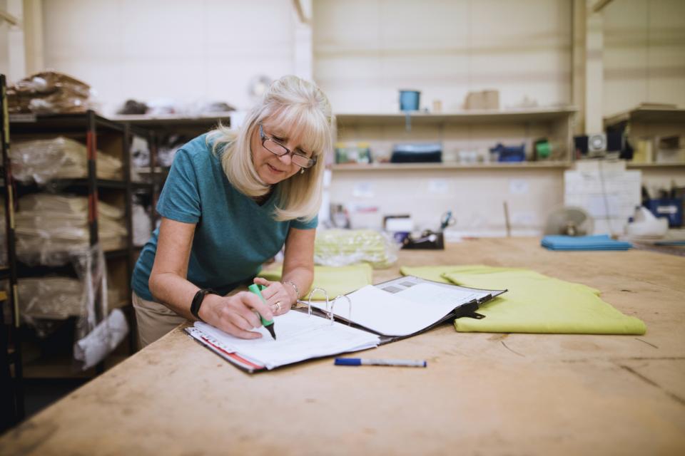 A professor marking work at her desk