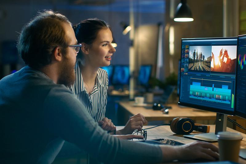 Man and woman working on film editing