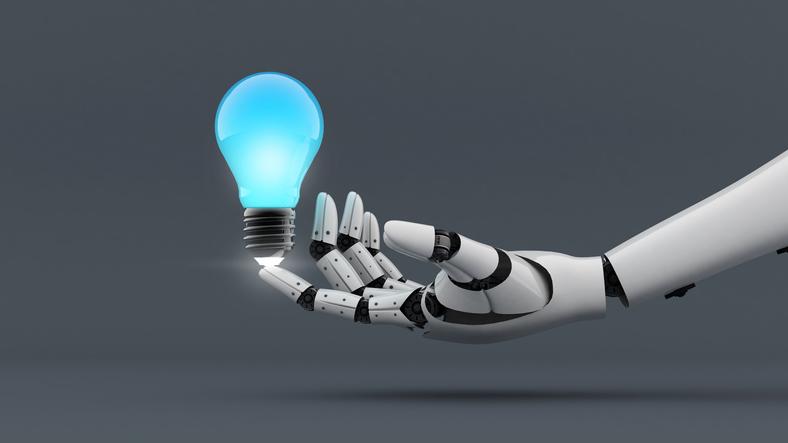 A robot hand holds a lightbulb