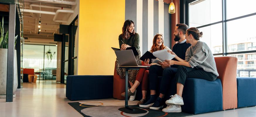 Young entrepreneurs chat happily in a breakout space