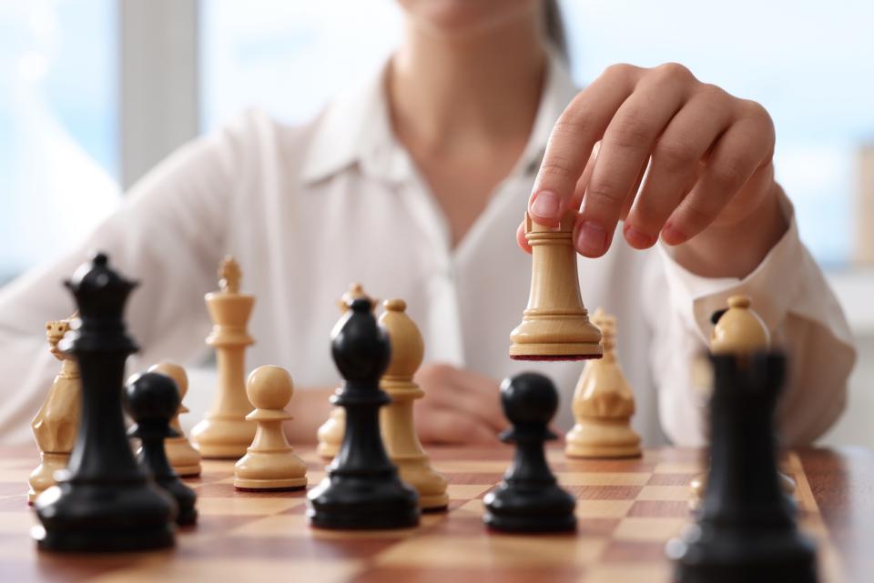 A chess player moving a rook across the board