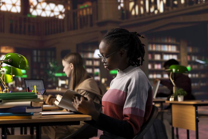 A young woman studies in a library