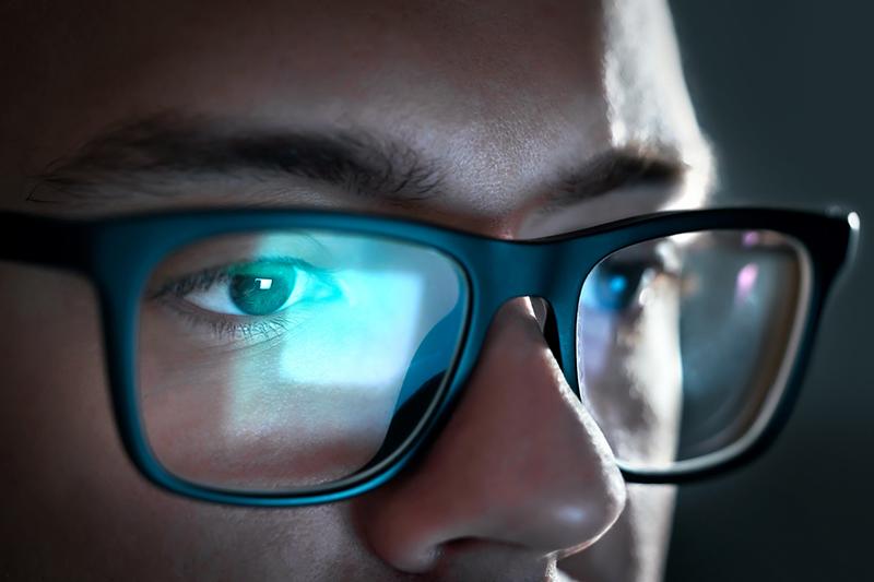Close up on young woman looking at computer screen