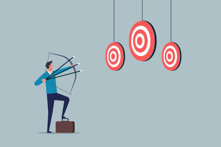 An illustration of a businessman attempting to hit three targets with one bow