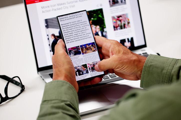 Someone reads the news on their phone
