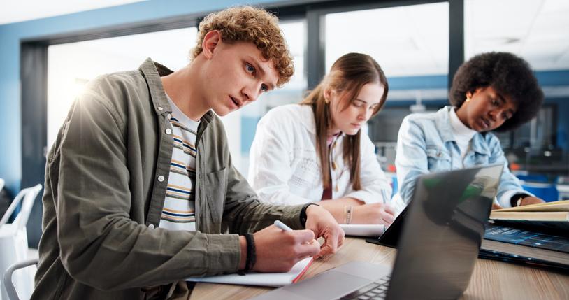 Students work together round a table