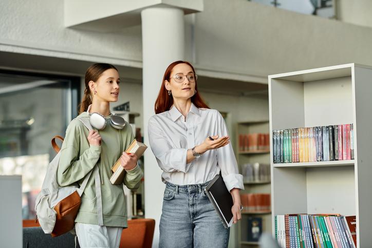 A librarian guides a student
