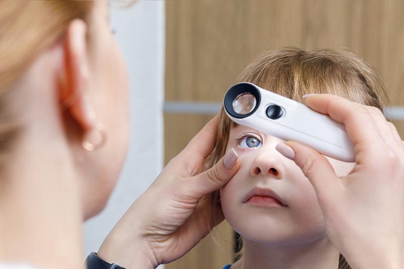 ophthalmologist examining a child's eye