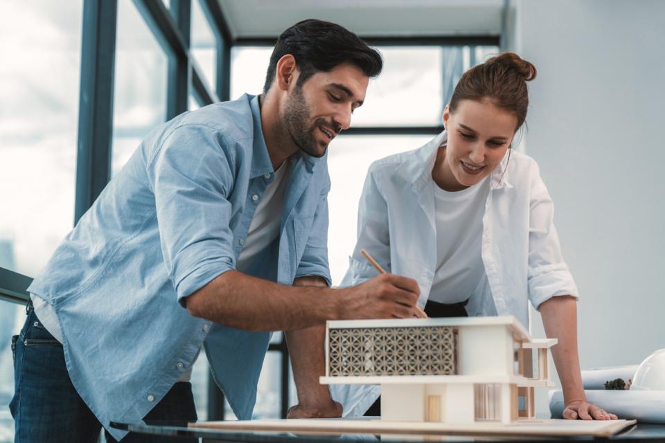 Two designers making a model of a building