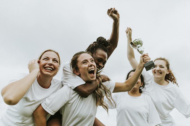 Women footballers celebrating victory