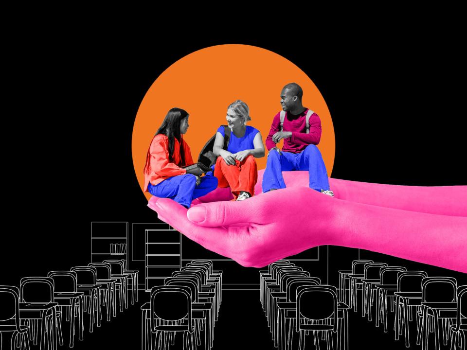 Three students are supported by cupped hands in a classroom