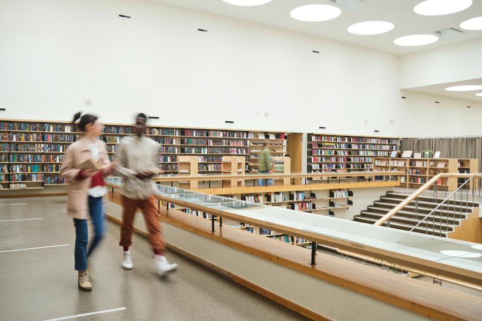 Students walking through a university library