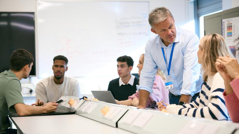 A teacher discusses with students in the classroom
