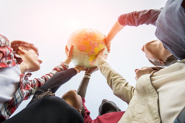 Students hold up an inflatable globe