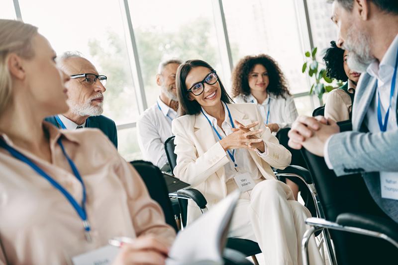 Group of professionals seated talking at a networking event