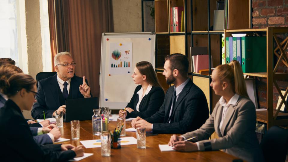 A researcher pitching to a room full of investors