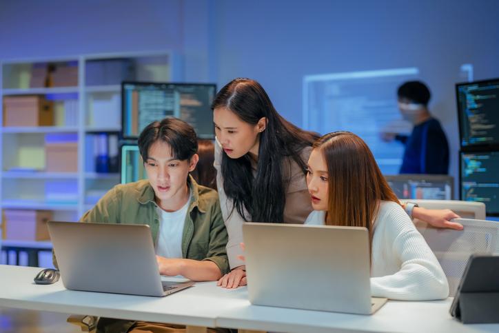 Students work together over a laptop