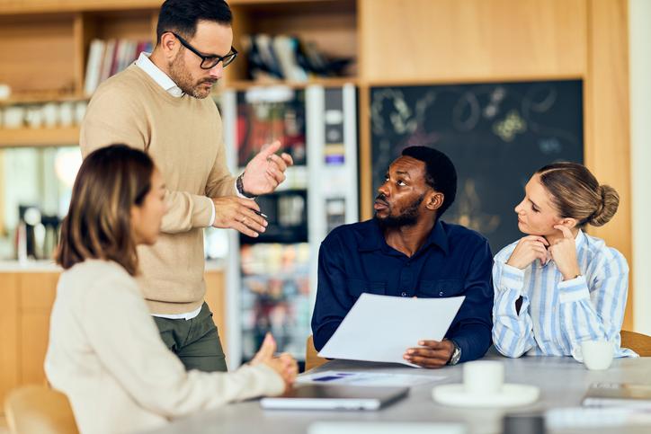 Academics discuss around a meeting table