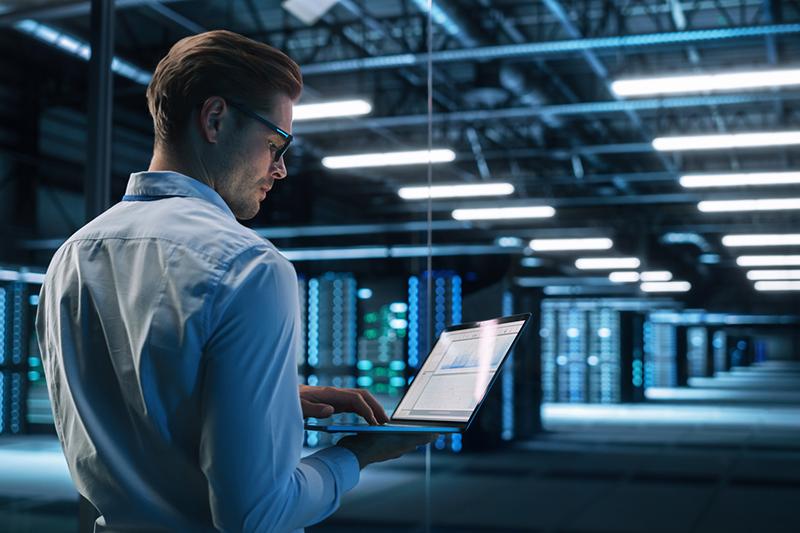 Man with laptop in a data centre