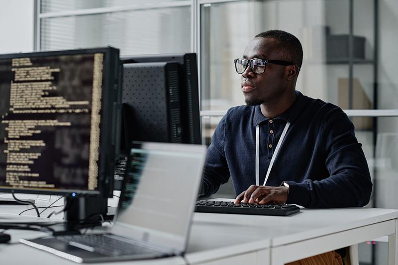 Young black man working at a computer terminal