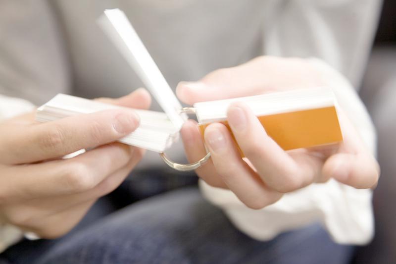 Close-up of hands flicking through flashcards