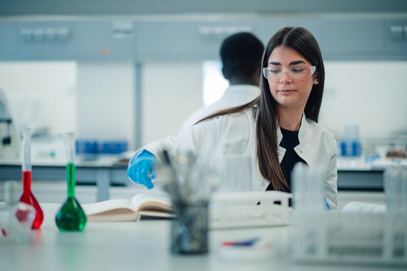 Young female student wearing safety glasses in an organic chemistry lab