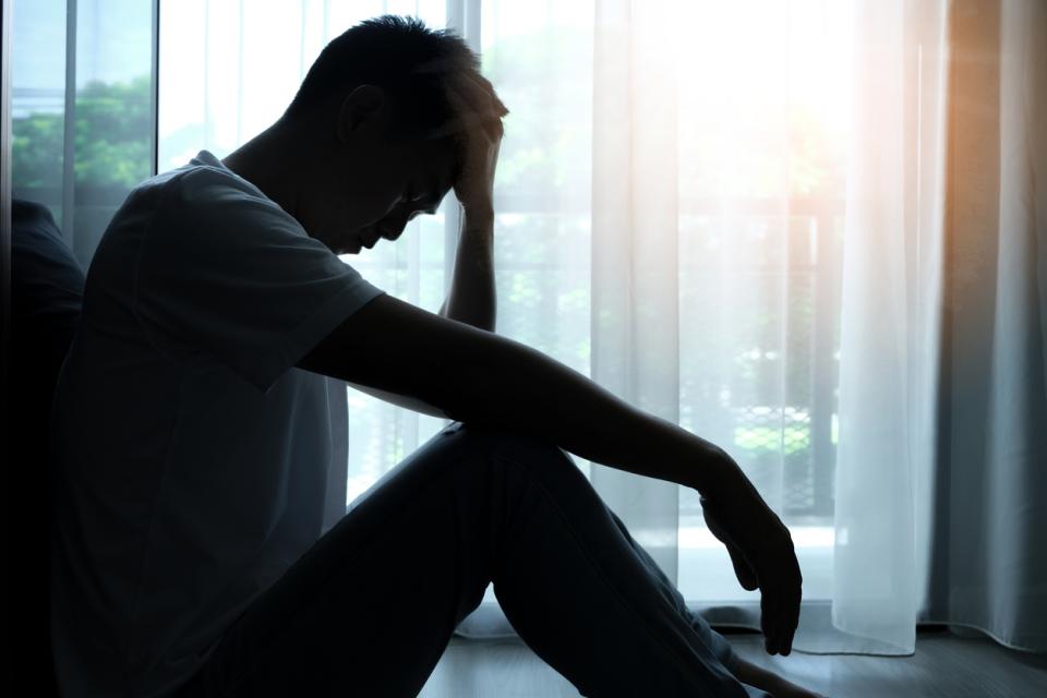 Man sitting alone in a state of distress or worry