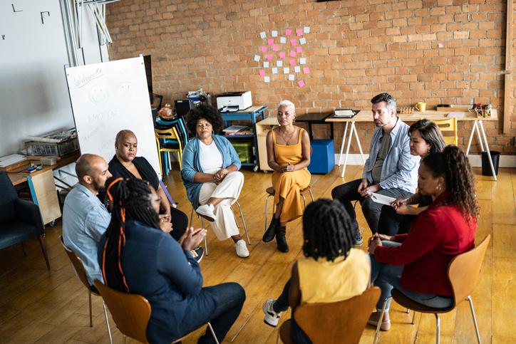 Research participants sit together in a circle