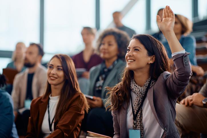Students raising their hands in class