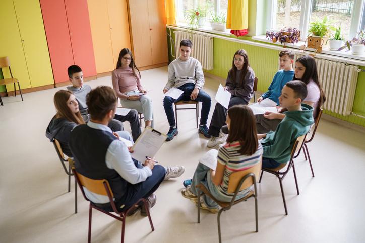 Students sitting in a circle with no desks
